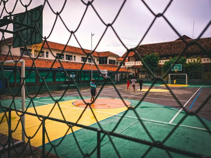 Basketball court with hoop and paved surface